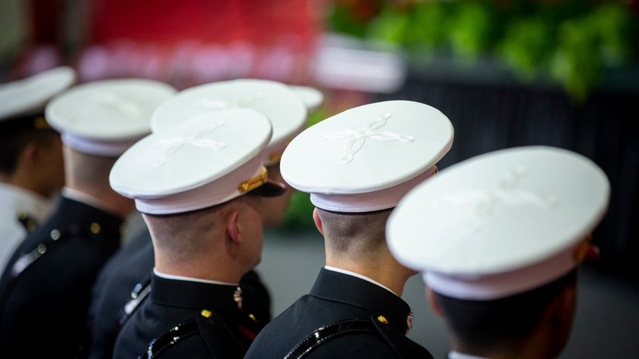 Five ROTC members stand facing forward at the Commissioning Ceremony May 24 at Barton Hall.