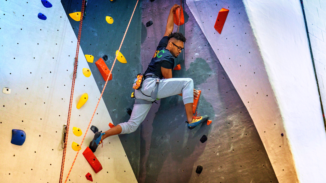 Man indoor rock climbing