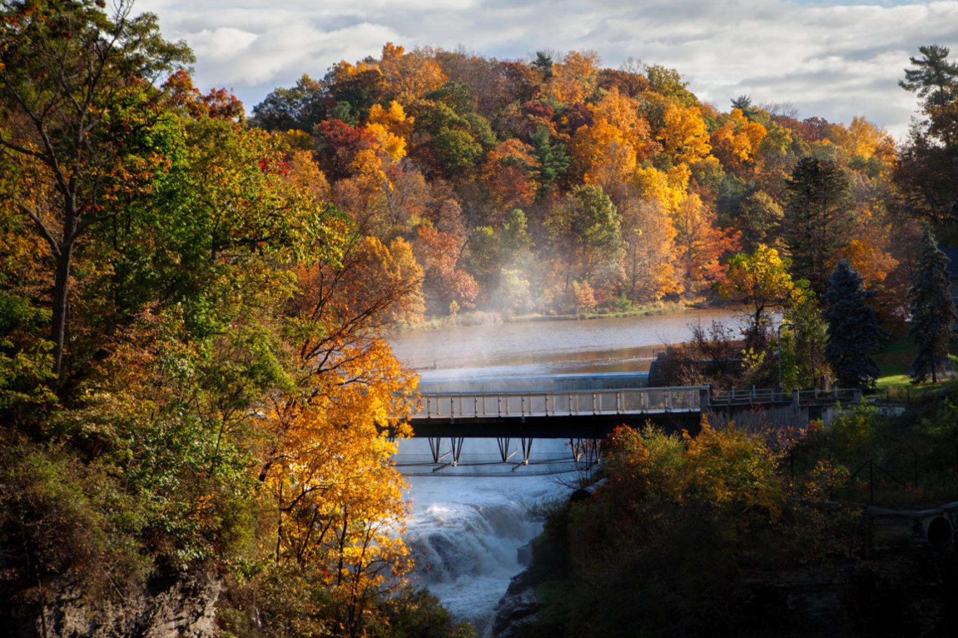 Beebe Lake and the Triphammer Foot Bridge in fall.