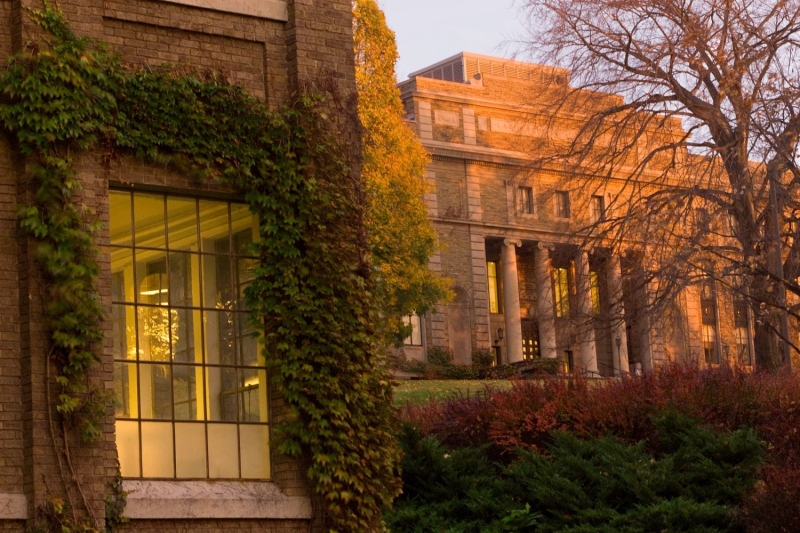An external shot of Baker Hall in the fall. As the sun goes down, the building has a warm glow.