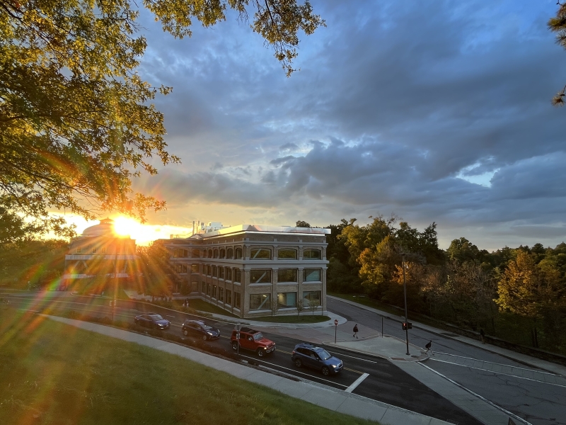 The sunset over buildings on the Arts Quad taken as a student left Baker Hall.