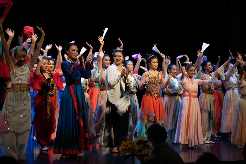 Students wave to the audience after their performance