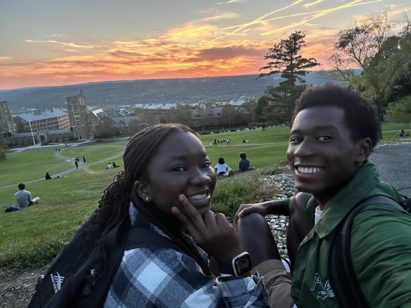 Two friends sit together on Libe Slope