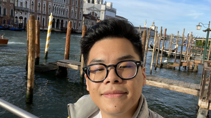 Bentley poses for a selfie by a dock while studying abroad