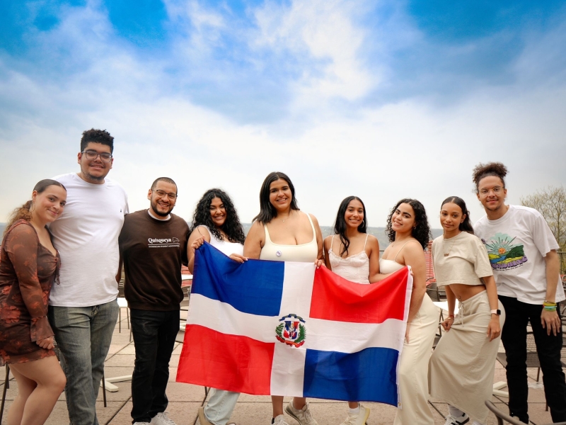 Emely R and students from Quisqueya pose with the Dominican flag