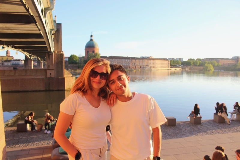 Gio and Emily pose by the water in France.