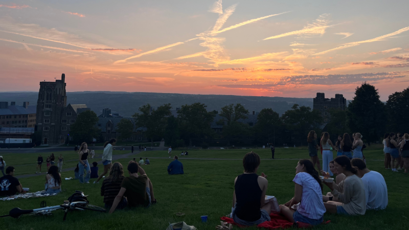 Groups of students enjoy sunset at the base of Libe Slope.