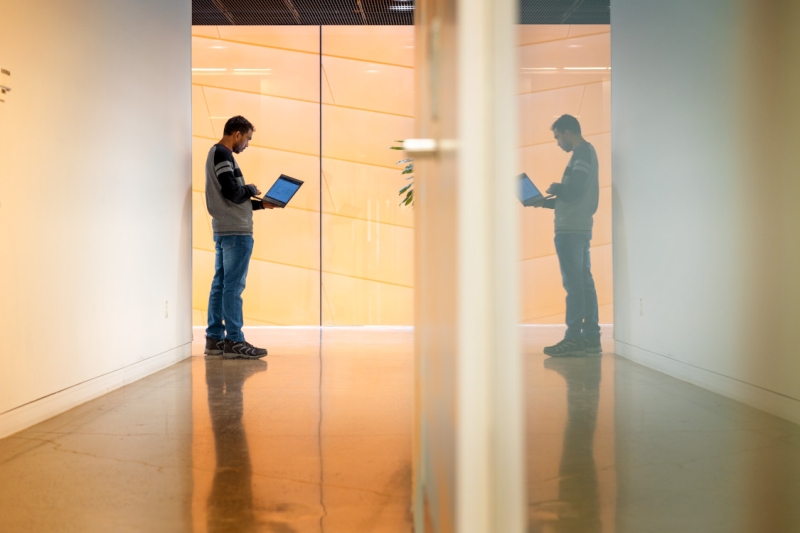 A student works in the hallway of Gates Hall.