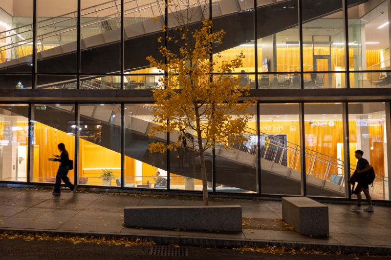 Students pass Breazzanno Center at night.