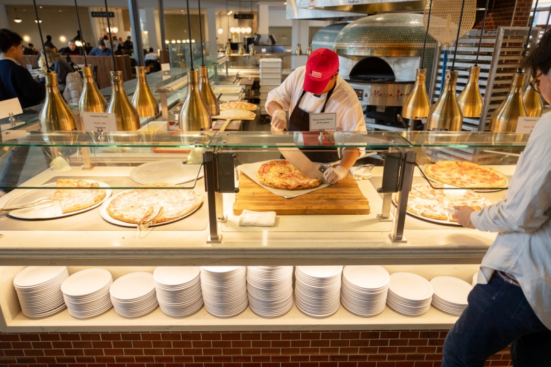 Fresh pizza is cut at Morrison Dining on North Campus.