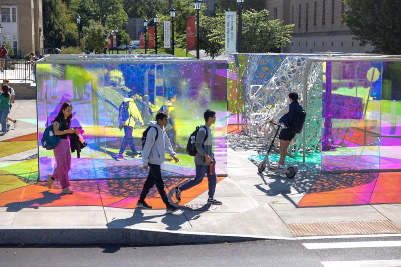 Students pass by the PolyForm sculpture near Martha Van Rennsselear.