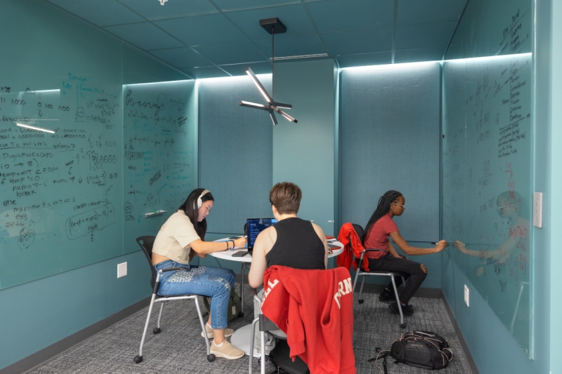 The new Martin Y. and Margaret Lee Tang Hall: Students work on a project together in a study space.