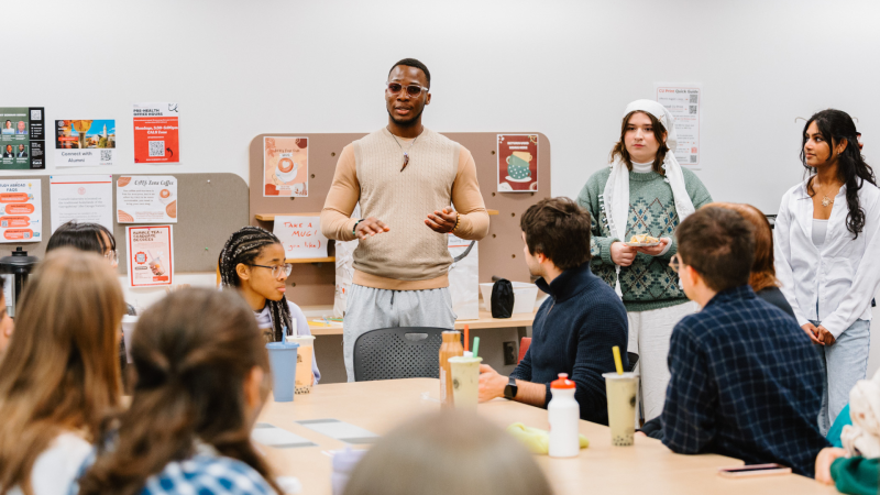 Kingsley presents to a group of students.