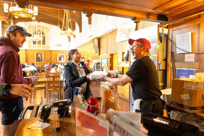 Garry Gale, door checker at Risley Dining Hall, chats with members of the campus community as he rings their lunches up at lunch time.