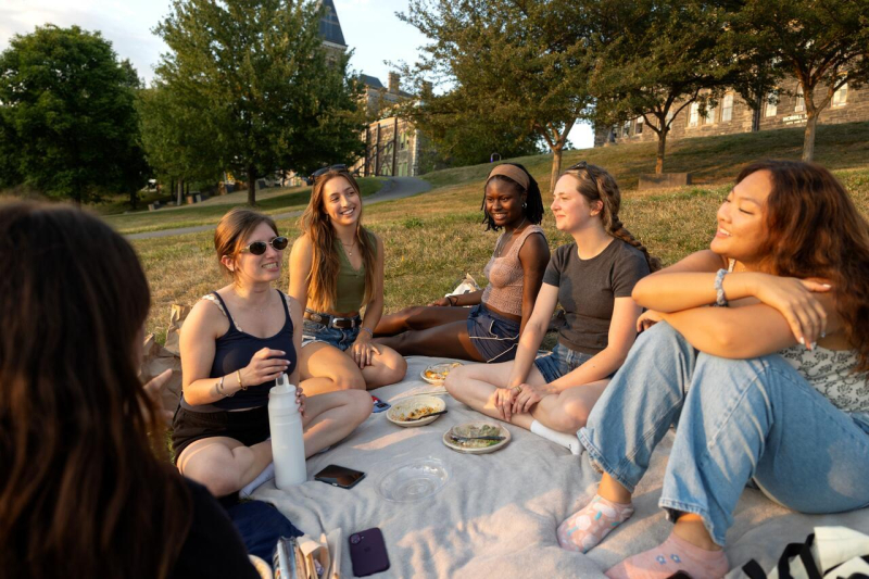 Students enjoy the evening light on the slope