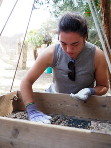 Grace sifting for artifacts at the dig site in Italy.
