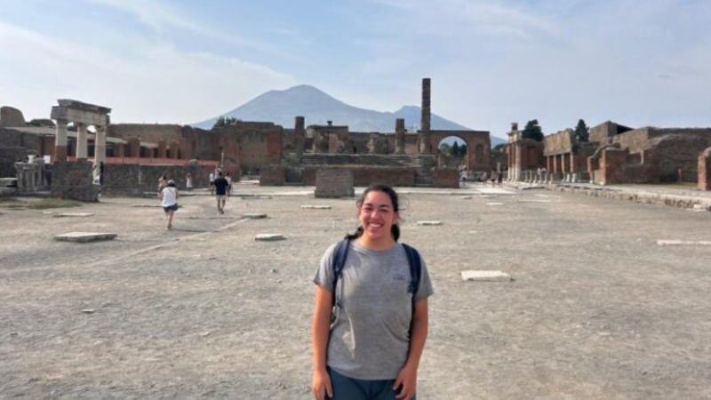 Grace stands in front of the Casa della Regina Carolina Project at Pompeii.