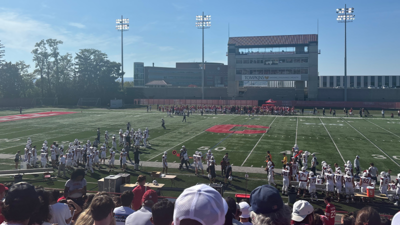 Fans in the stands cheer on Cornell football.