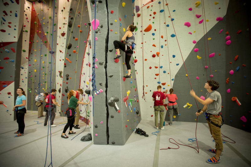 Students try out the new climbing wall at the 2016 Lindseth Climbing Center Dedication.