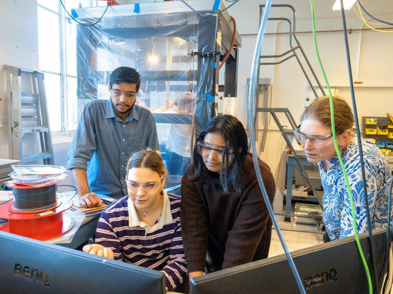 Members of John Marohn’s research team work with their electric force microscope to view tiny perovskite particles.