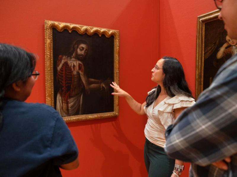 Ananda Cohen-Aponte, associate professor of history of art and visual studies , discusses a painting with students.
