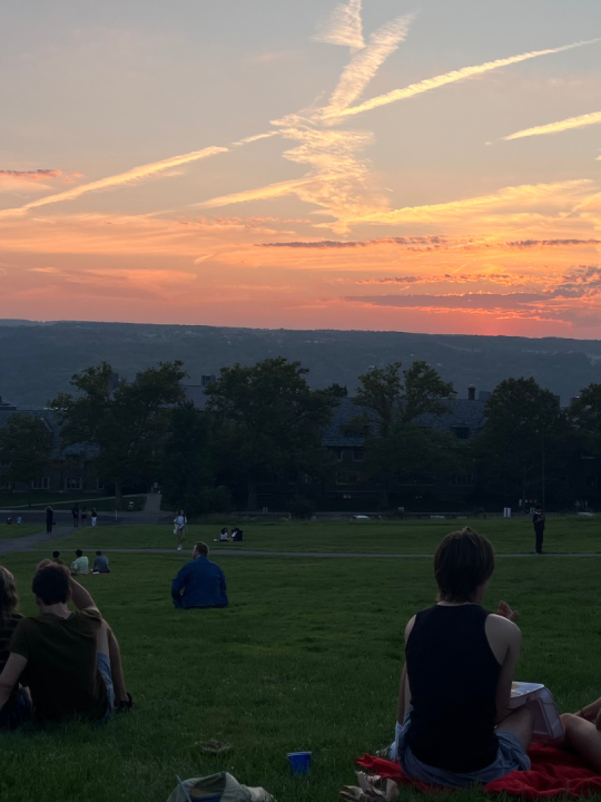 Groups of students enjoy sunset at the base of Libe Slope.