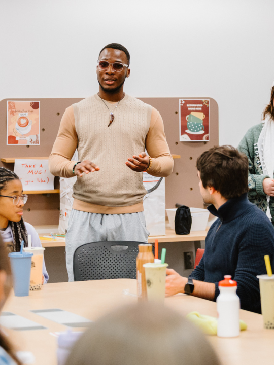 Kingsley presents to a group of students.