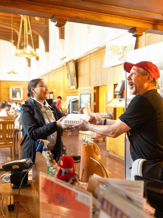Garry Gale, door checker at Risley Dining Hall, chats with members of the campus community as he rings their lunches up at lunch time.