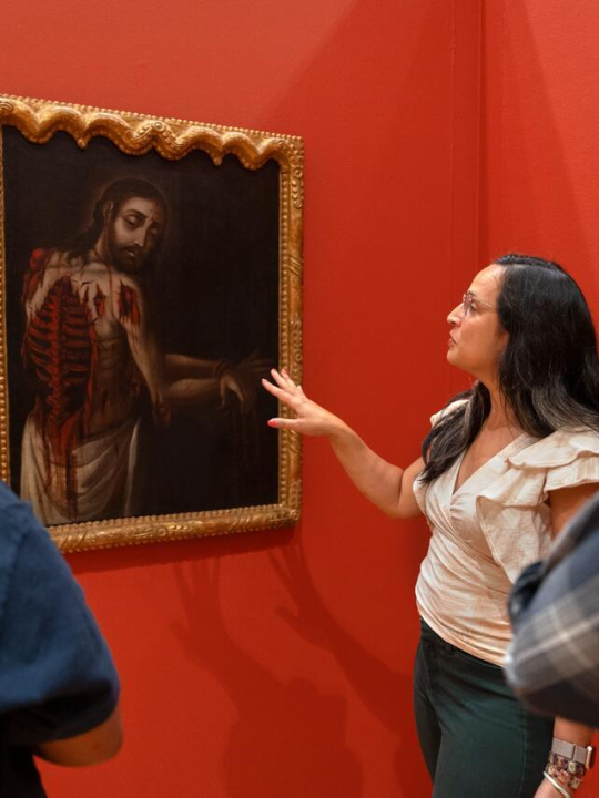 Ananda Cohen-Aponte, associate professor of history of art and visual studies , discusses a painting with students.