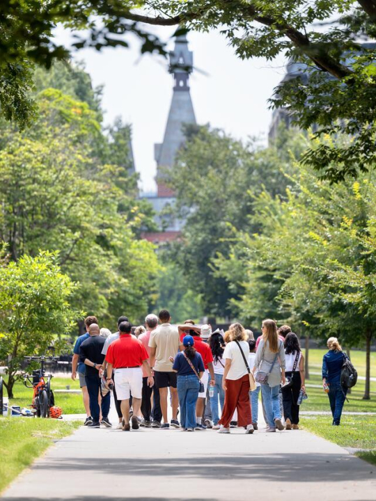 A summer tour group makes its way through the Arts Quad.