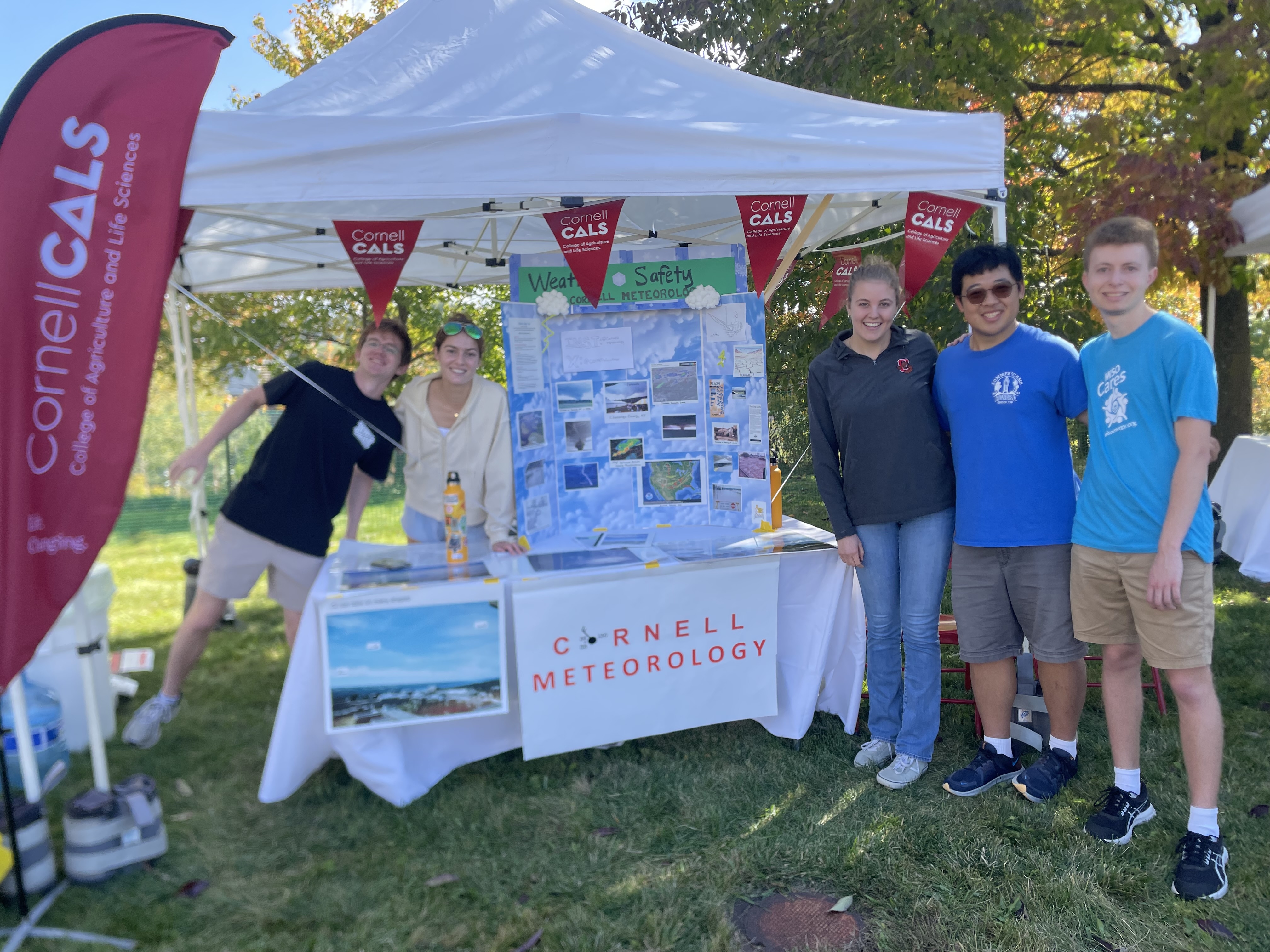 Students gather at a booth for the Cornell Weather club. 