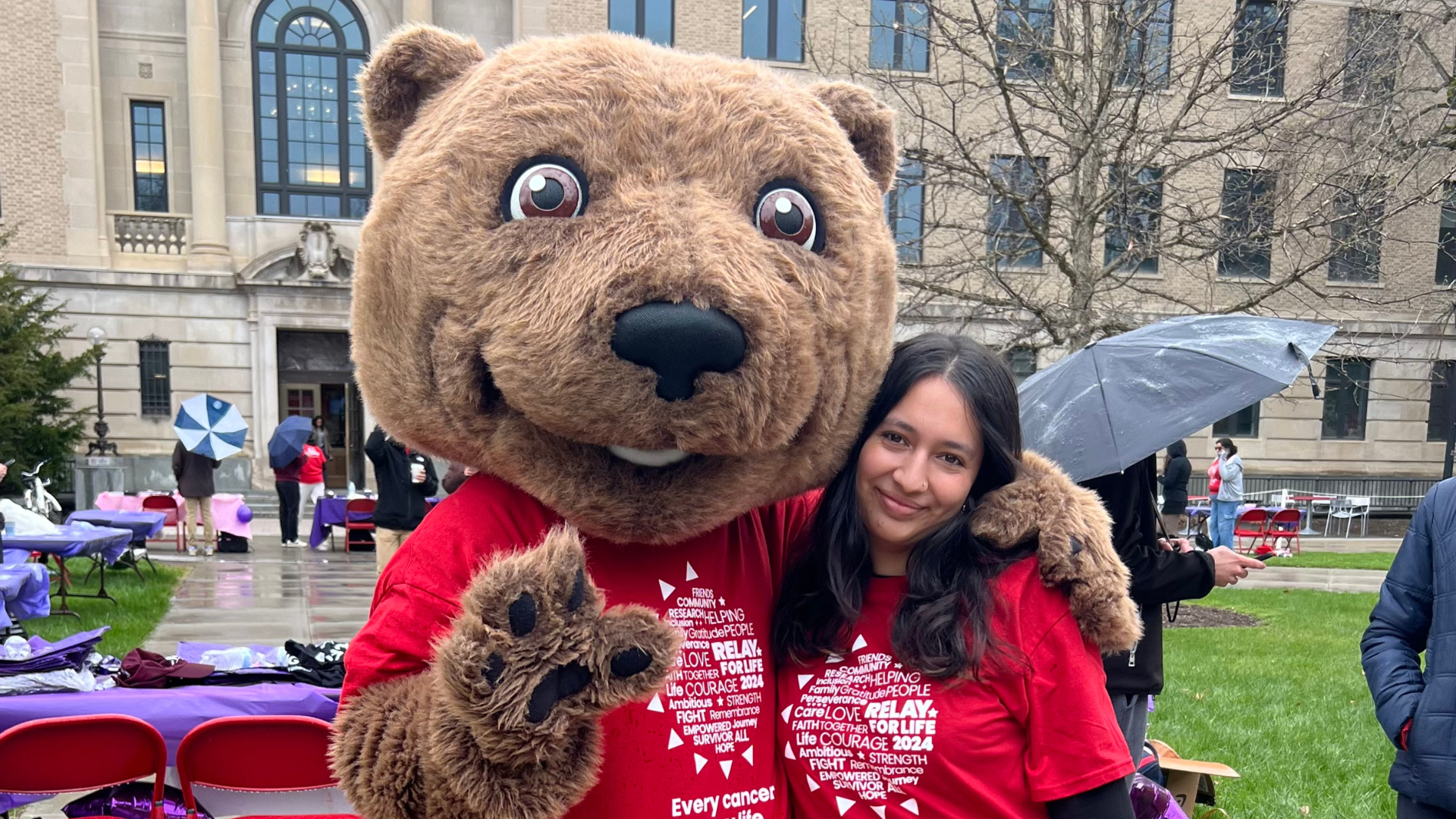 Nimisha G poses with Touchdown the bear.