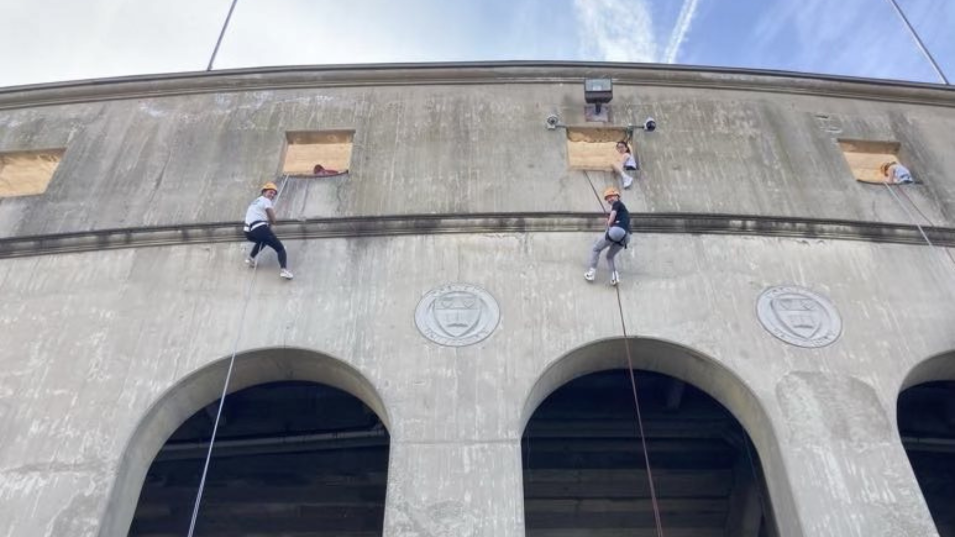 Students descend the outer wall of Schoellkopf Field.