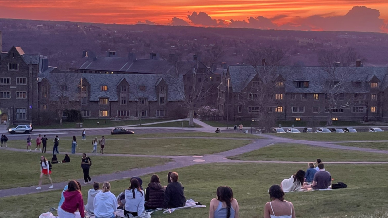 Student enjoy sunset on Libe Slope